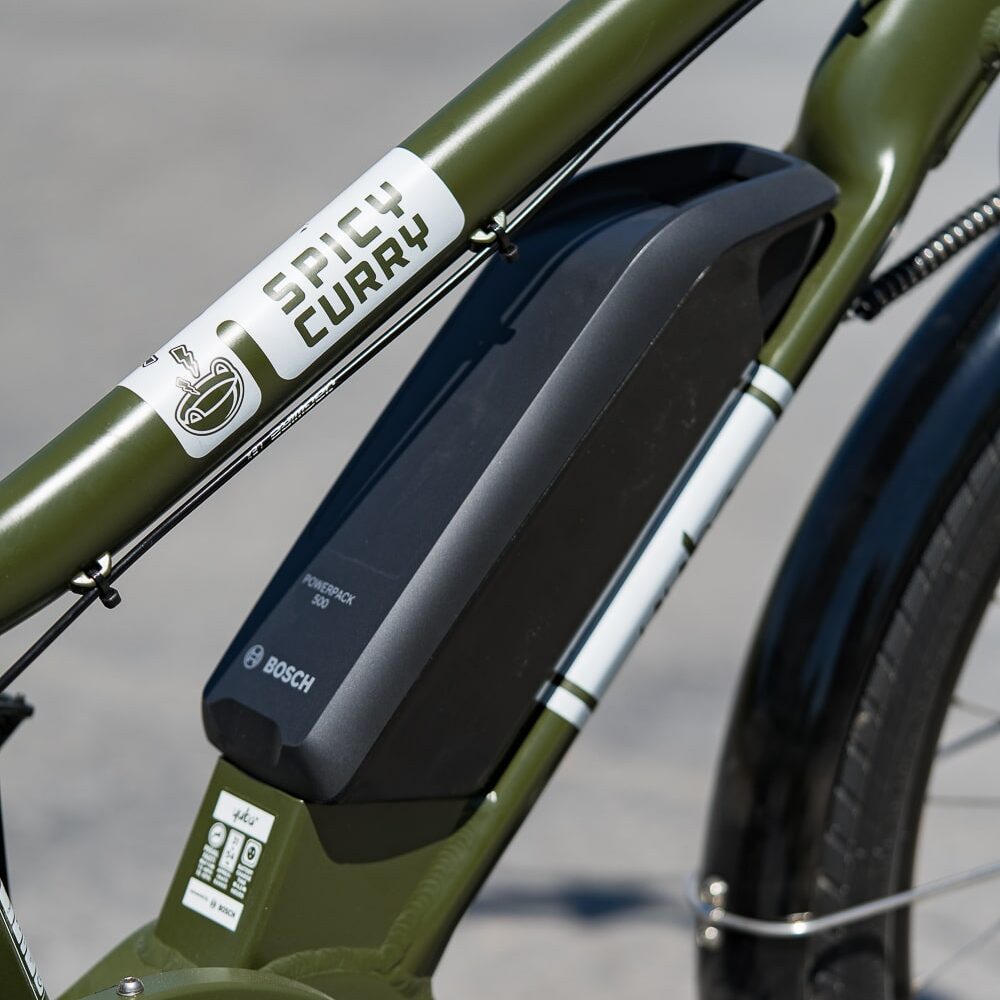 yuba_bikes_spicy_curry_green_dual_closeup_battery_bosch-min